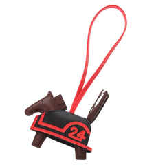 Hermes Robeo 24 PM Agneau Milo Black Terre Capucines K stamp (2025 production) Accessory Bag Charm 1119 HERMES — New - Store Return