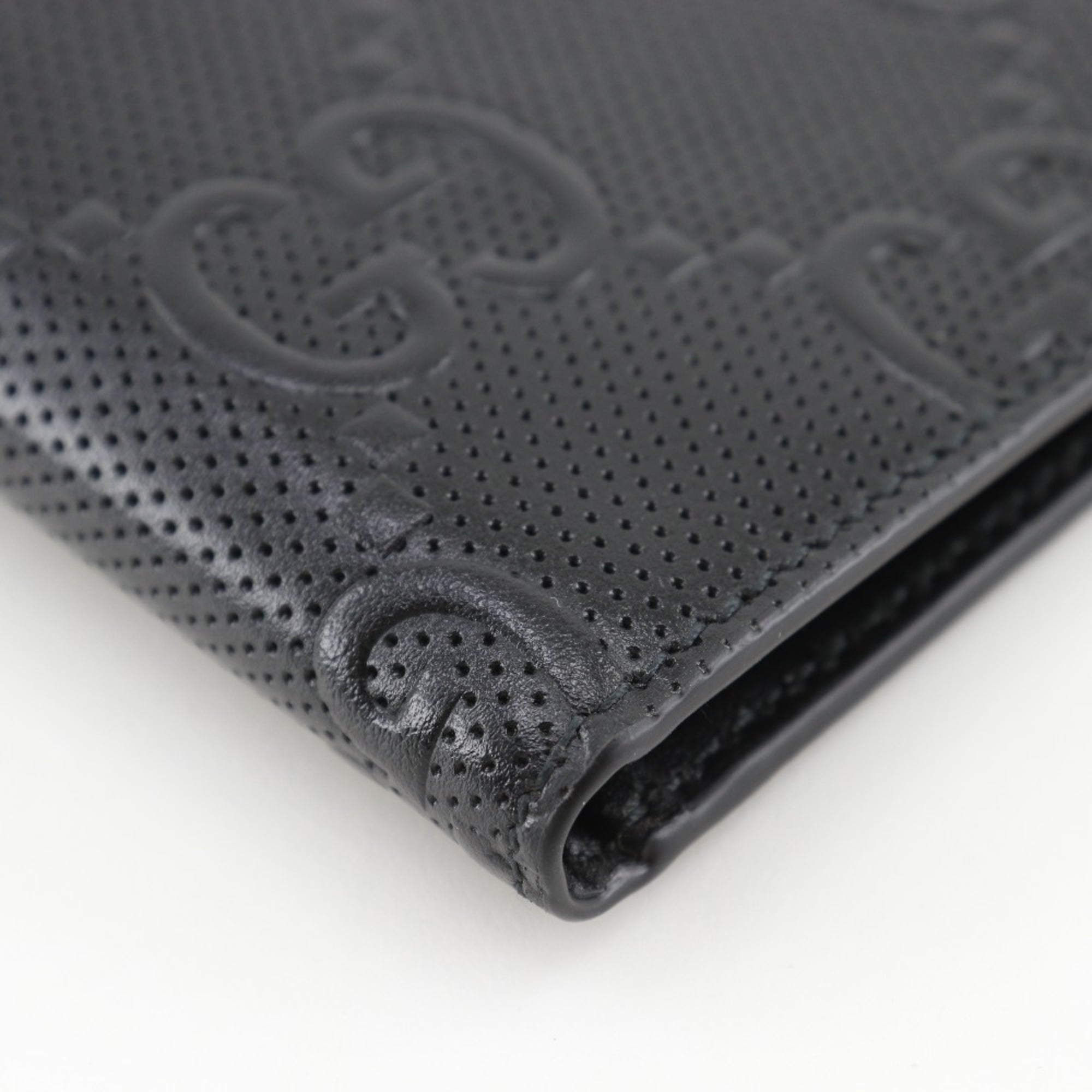 Gucci GG embossed bifold billfold 625559 in black calfskin with an open pattern for men