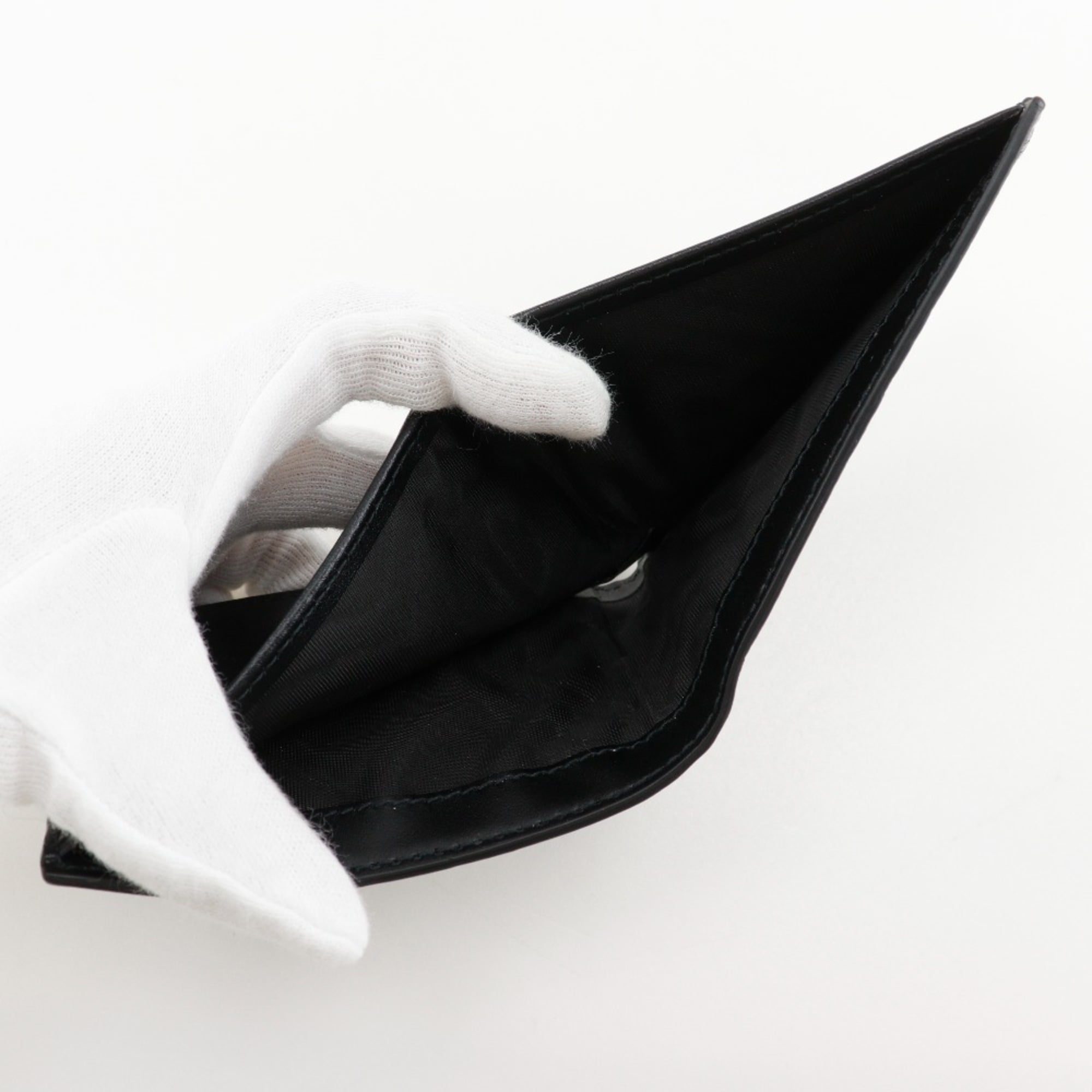 Gucci GG embossed bifold billfold 625559 in black calfskin with an open pattern for men