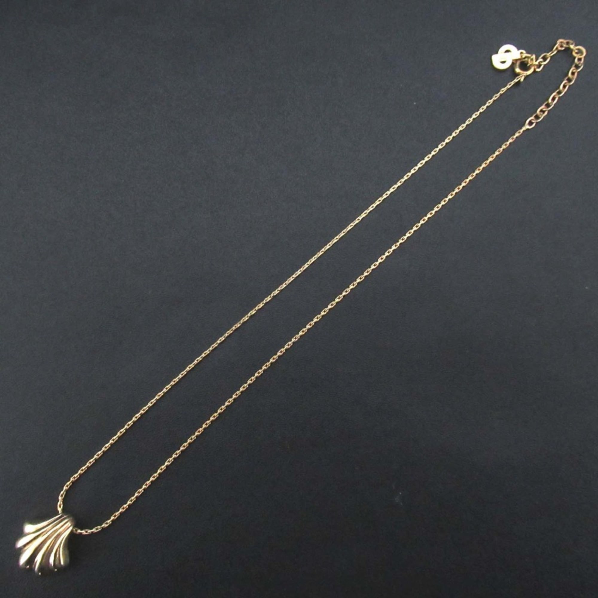 Vintage Christian Dior shell motif necklace pendant in gold for women.