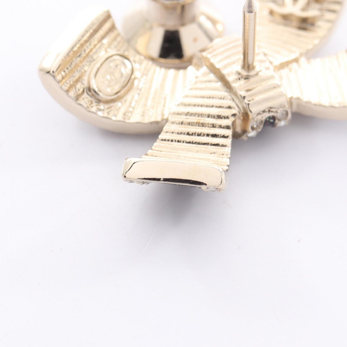 Chanel Coco Mark Ribbon Brooch with Gold-Plated Rhinestones, Available in Gold, Black, and Clear.