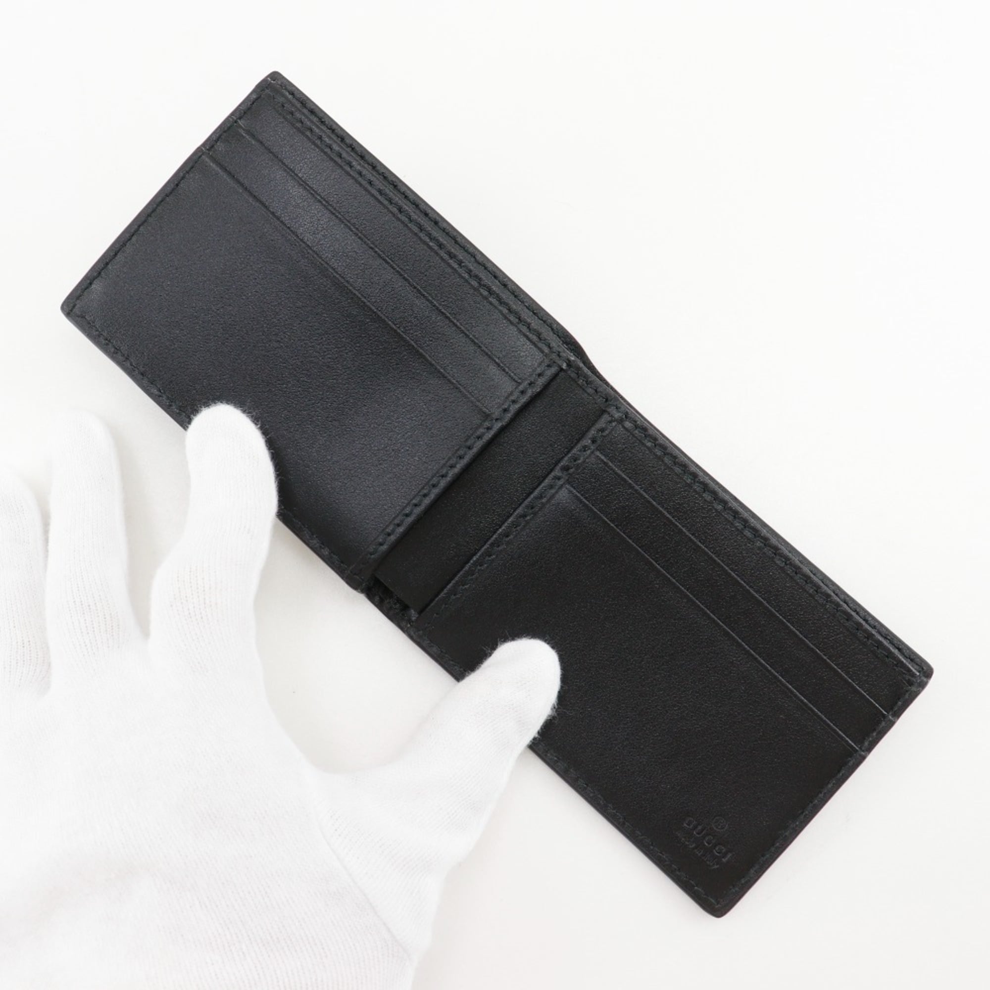 Gucci GG embossed bifold billfold 625559 in black calfskin with an open pattern for men