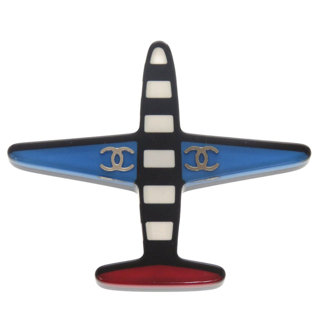 Excellent condition Chanel airplane Coco mark plastic brooch in blue, black, white, and red. 1361