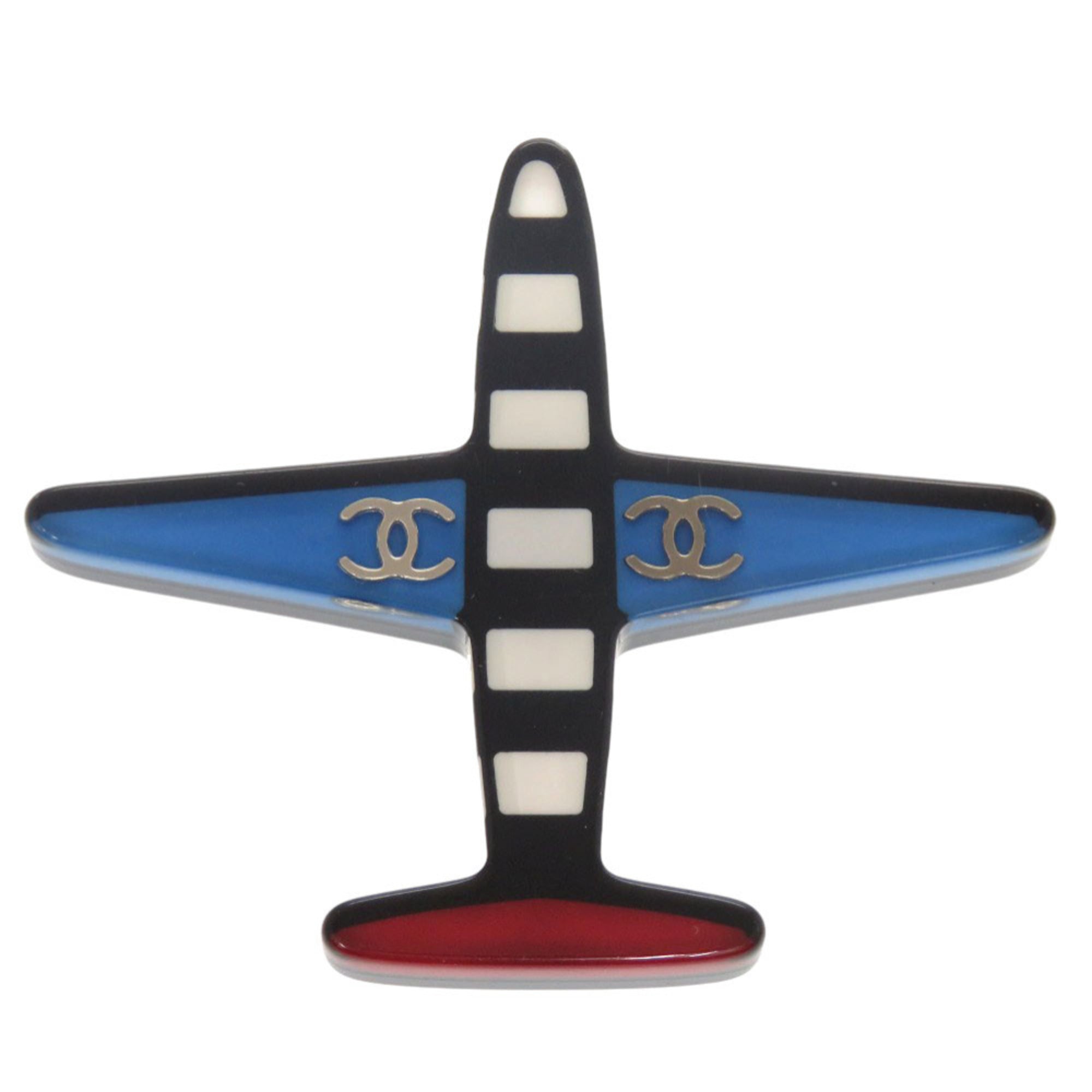 Excellent condition Chanel airplane Coco mark plastic brooch in blue, black, white, and red. 1361