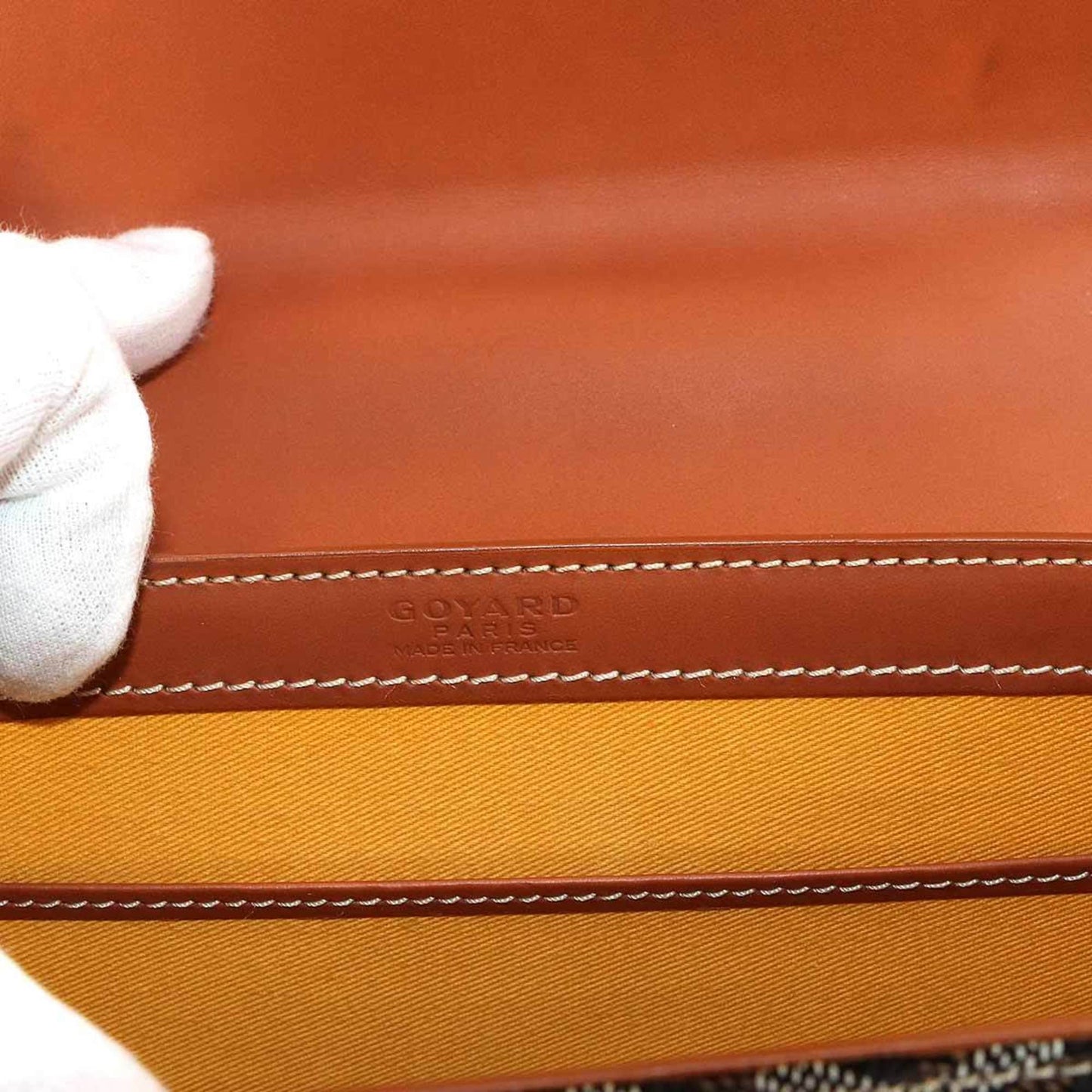 Goyard Saigon PM 2-way hand/shoulder bag in PVC, leather, wood, black, brown, and herringbone.