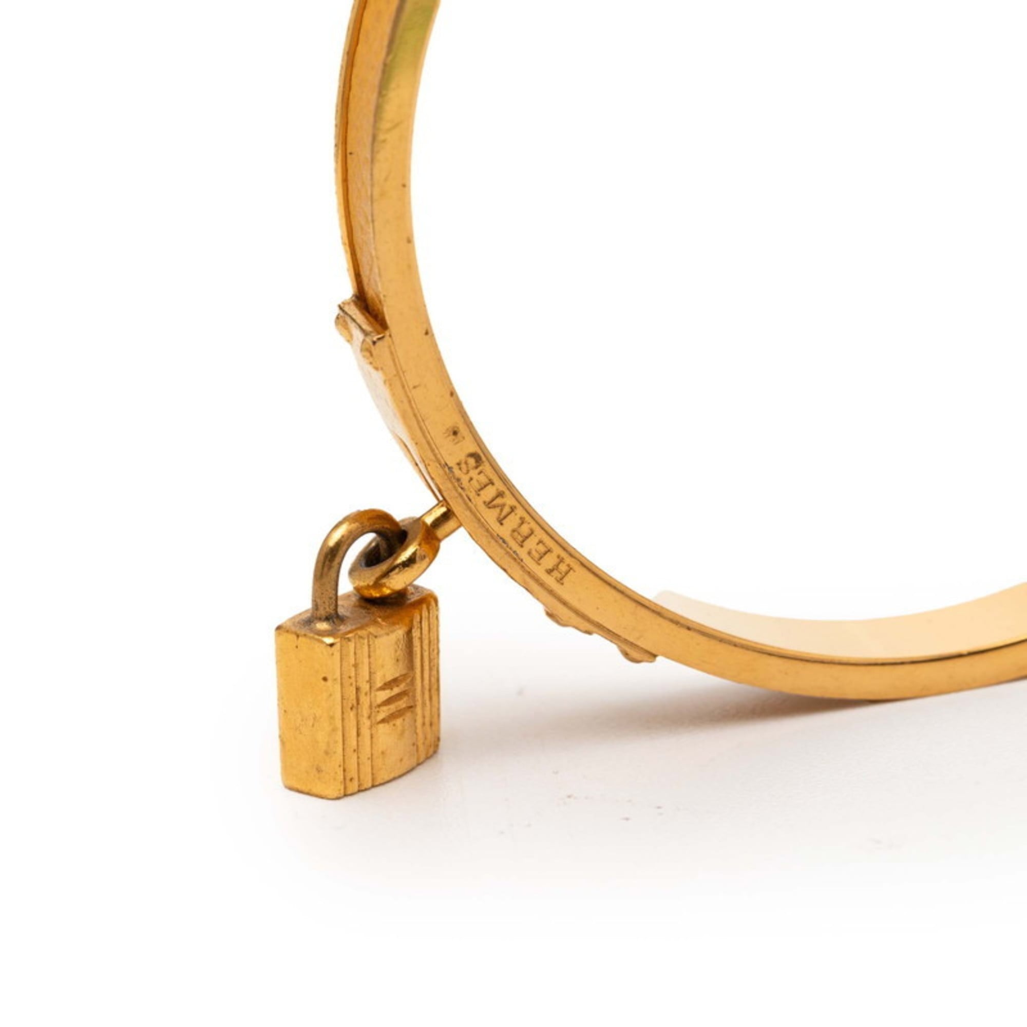 Hermes Kelly H motif bangle in gold and yellow plated for women.