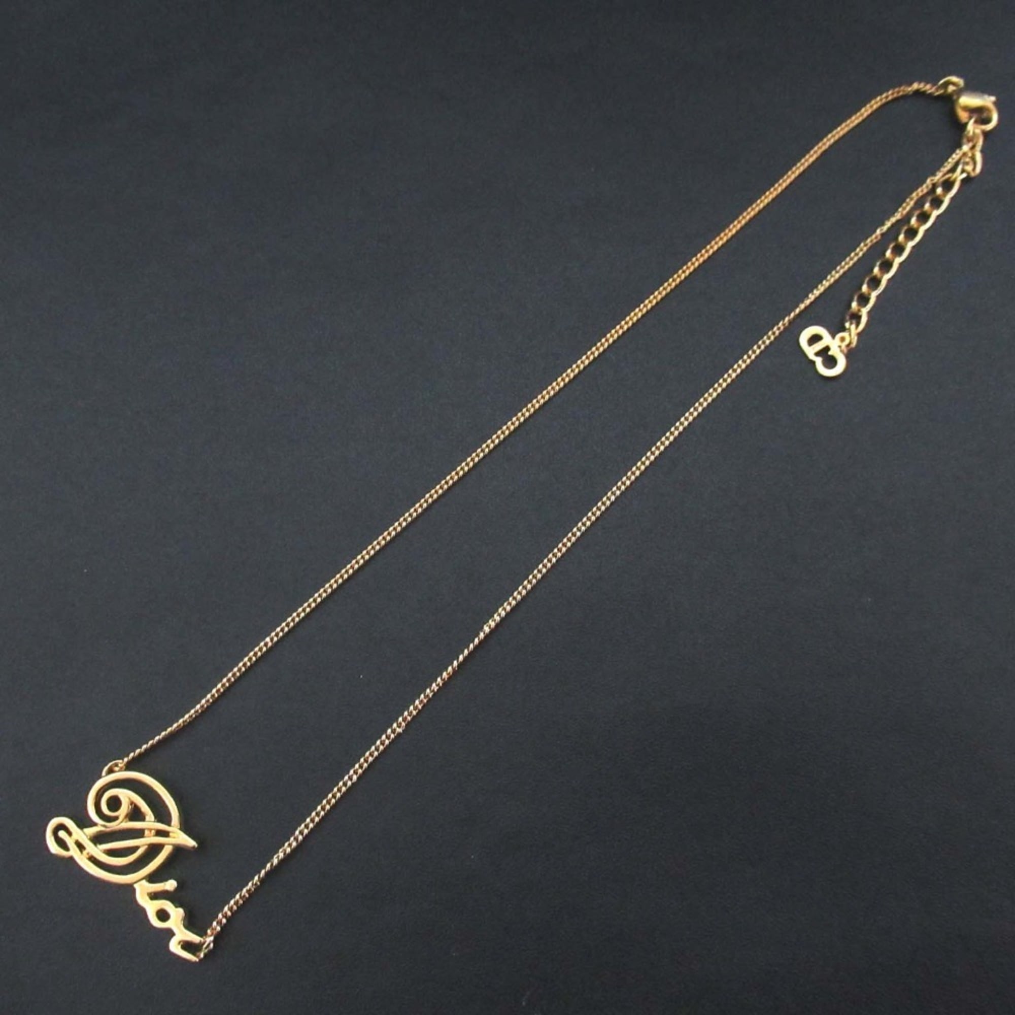 Vintage Christian Dior logo chain necklace pendant in GP gold for women.