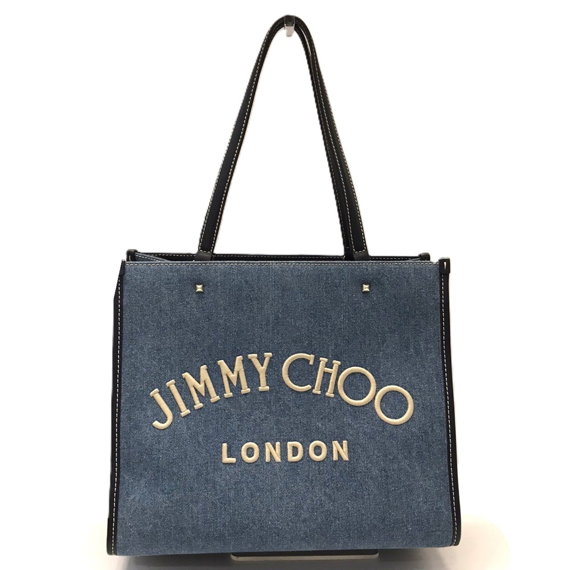 Jimmy Choo Varenne denim tote bag with embroidery and studs in indigo blue.