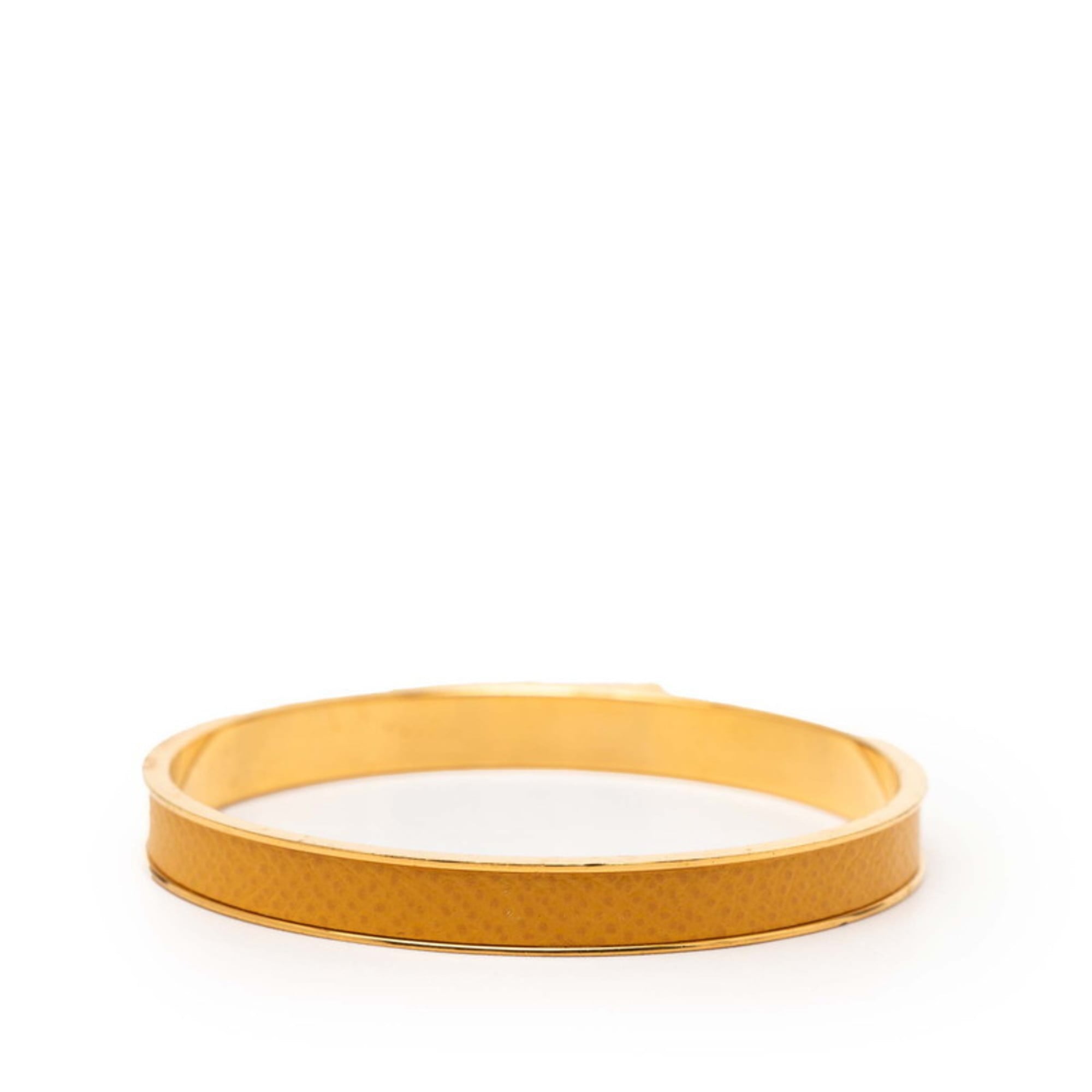 Hermes Kelly H motif bangle in gold and yellow plated for women.