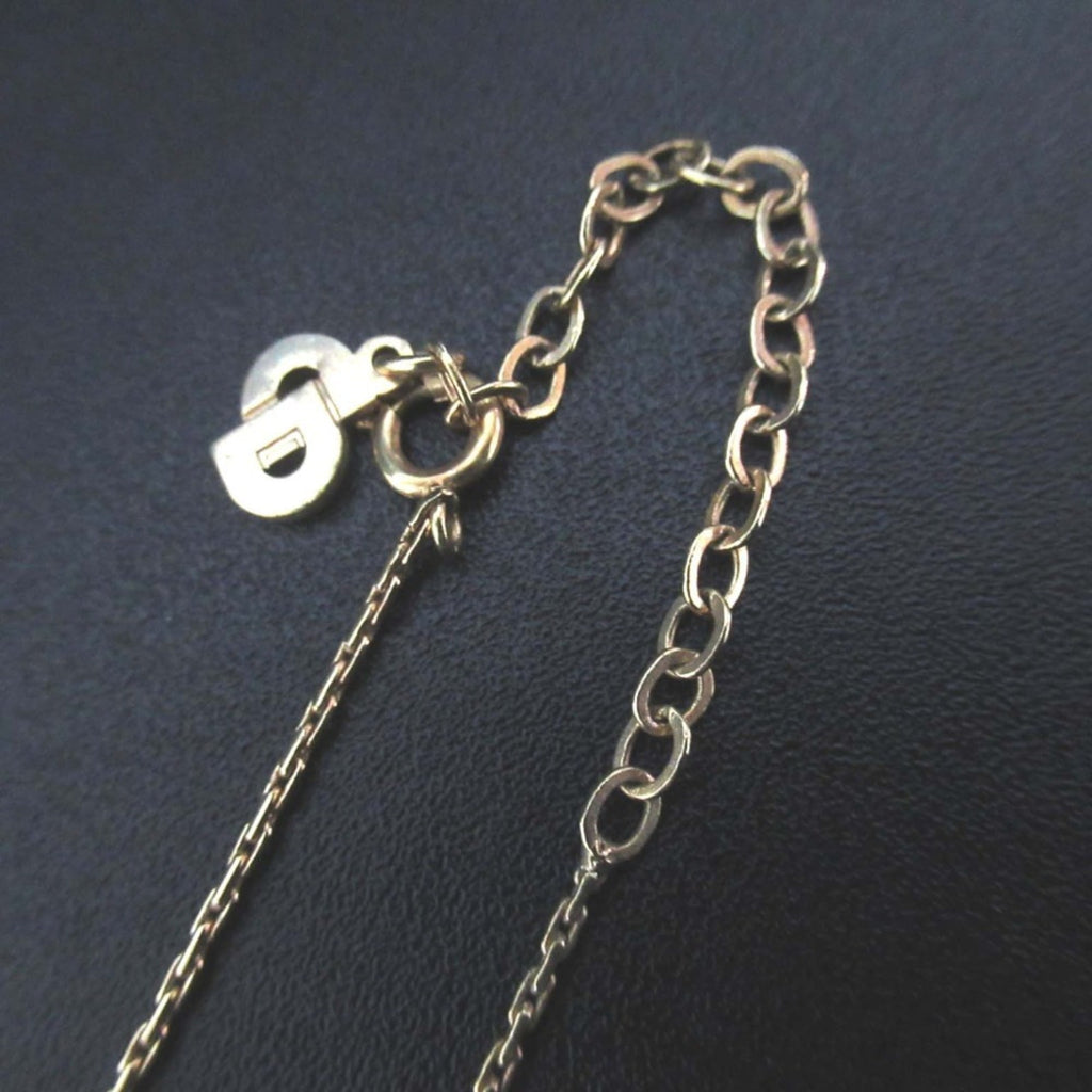 Vintage Christian Dior shell motif necklace pendant in gold for women.