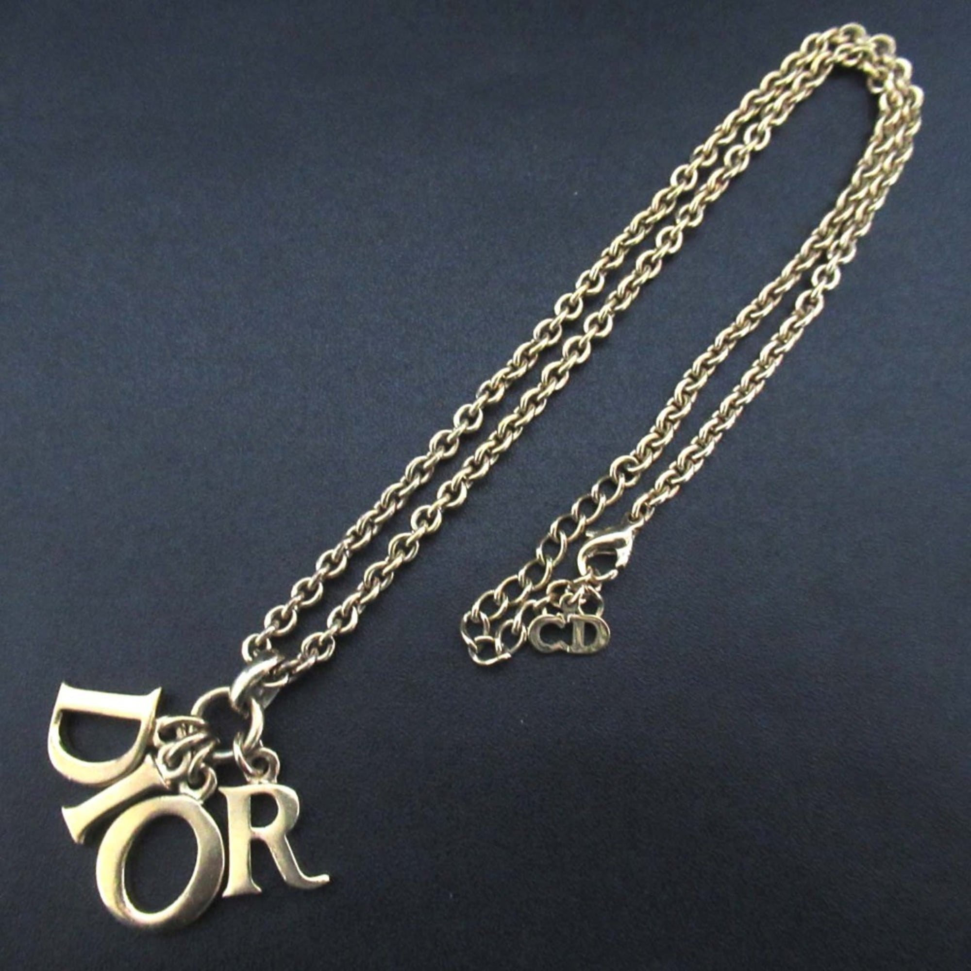 Vintage Christian Dior logo charm necklace pendant in GP gold for women.