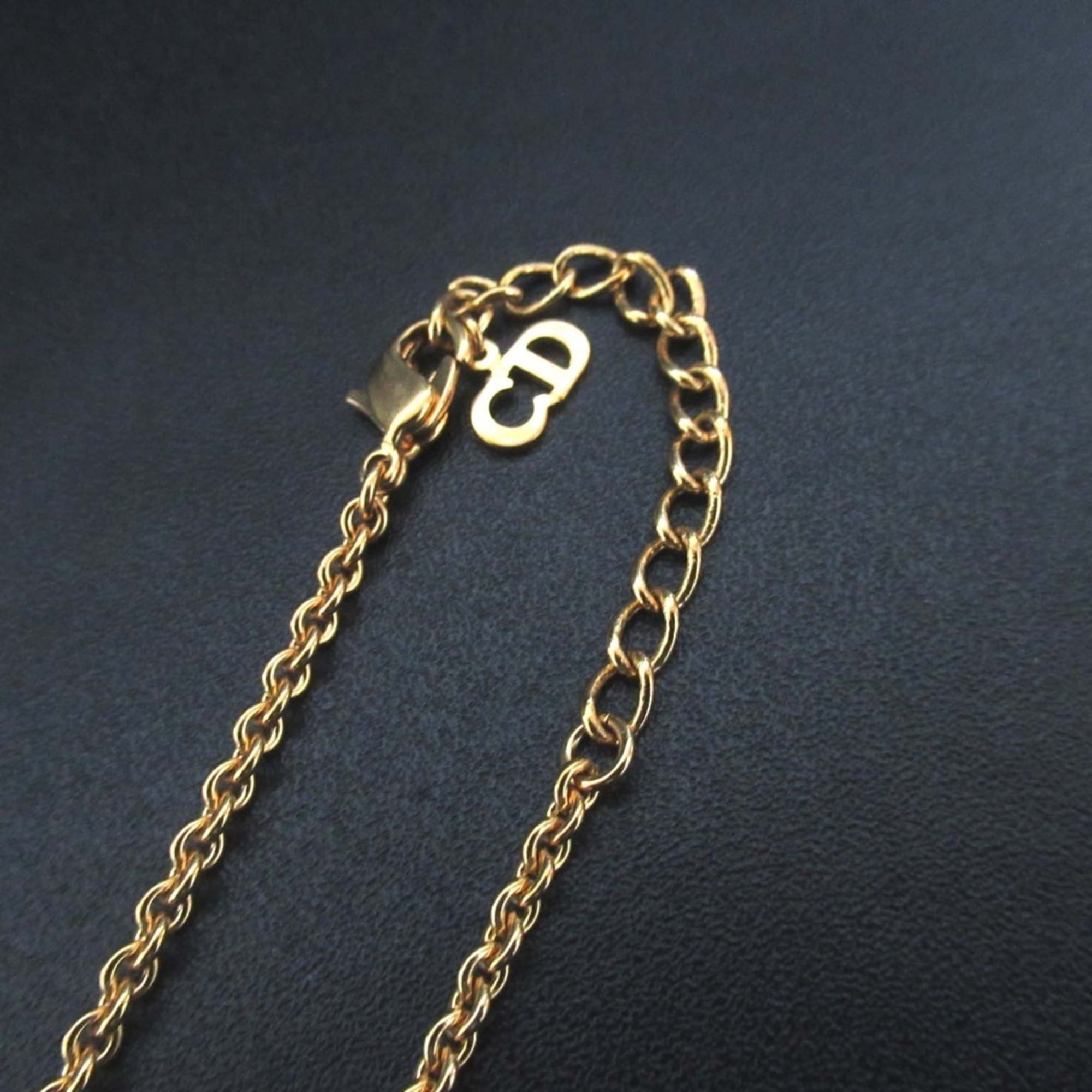 Vintage Christian Dior logo charm necklace pendant in GP gold for women.