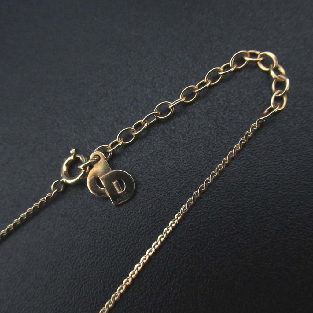 Vintage Christian Dior CD logo necklace pendant in gold for women.