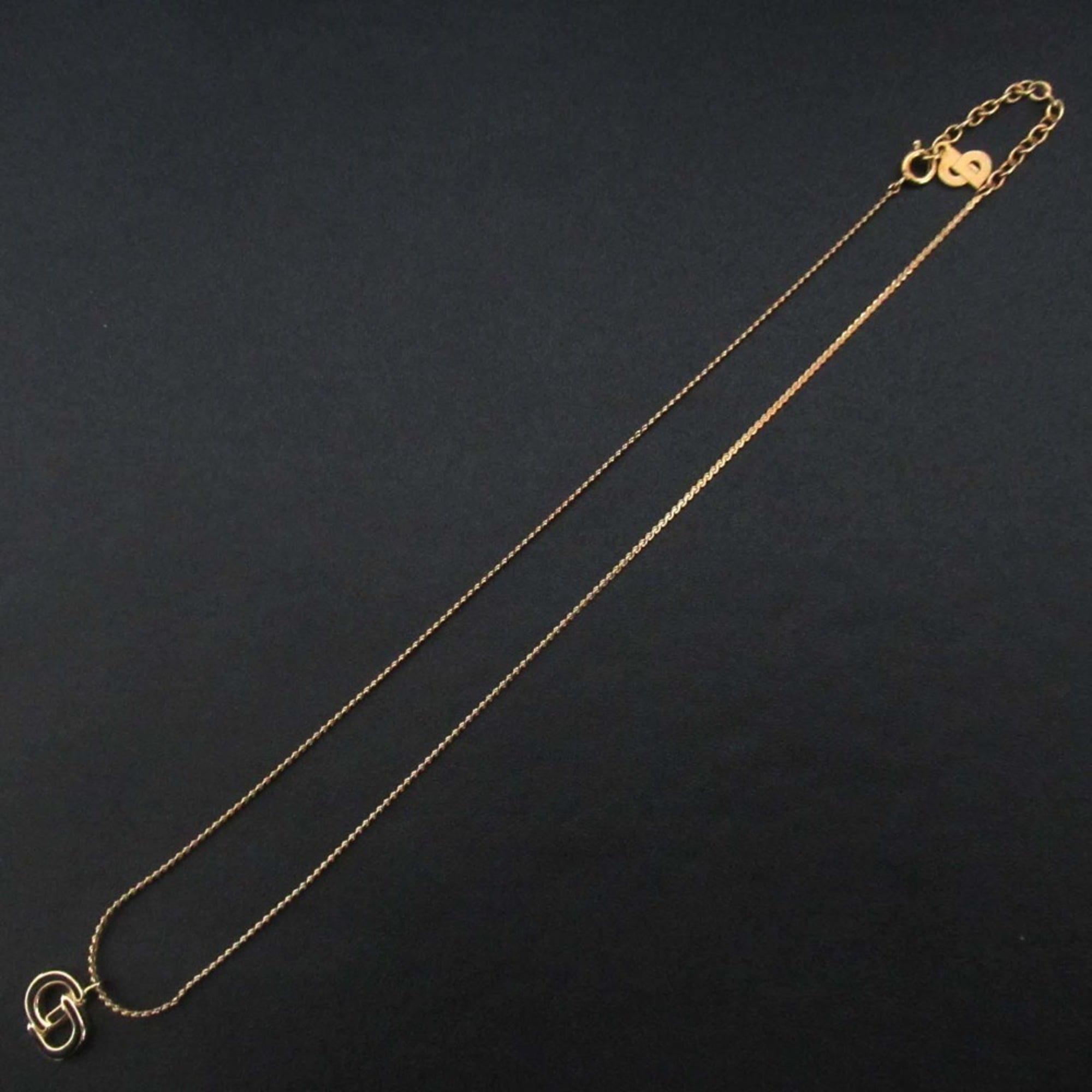 Vintage Christian Dior CD logo necklace pendant in gold for women.