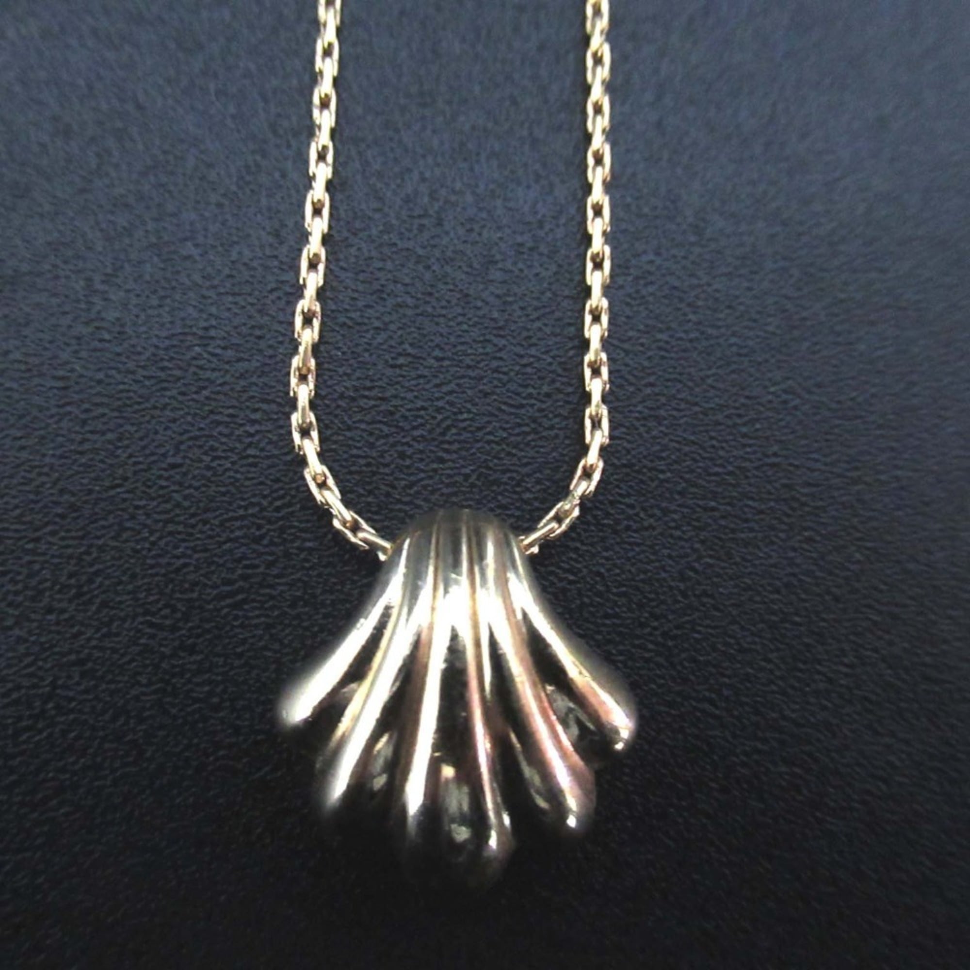 Vintage Christian Dior shell motif necklace pendant in gold for women.