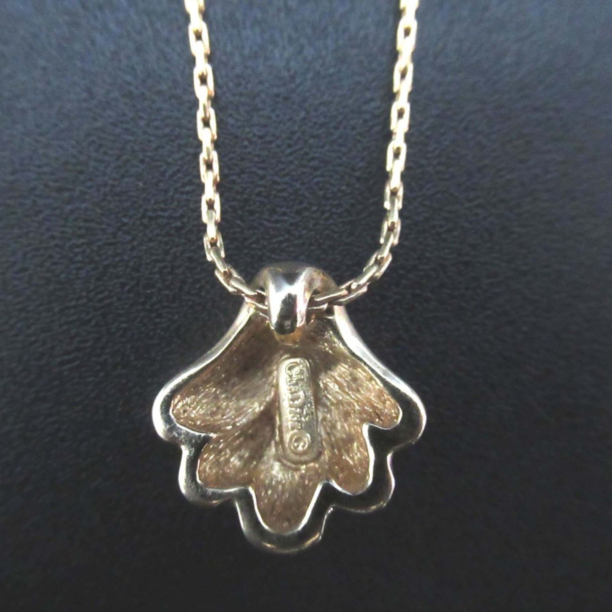 Vintage Christian Dior shell motif necklace pendant in gold for women.