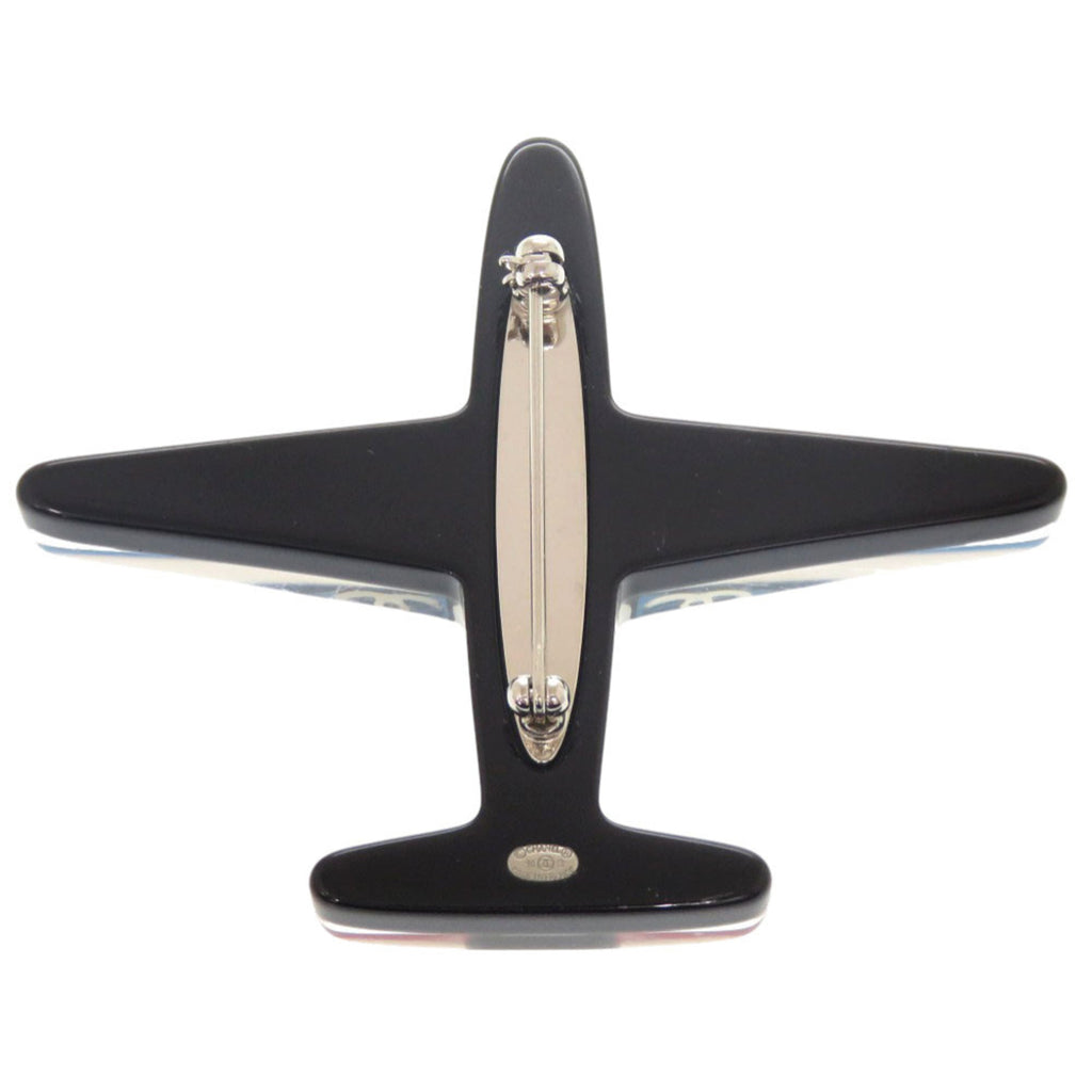 Excellent condition Chanel airplane Coco mark plastic brooch in blue, black, white, and red. 1361