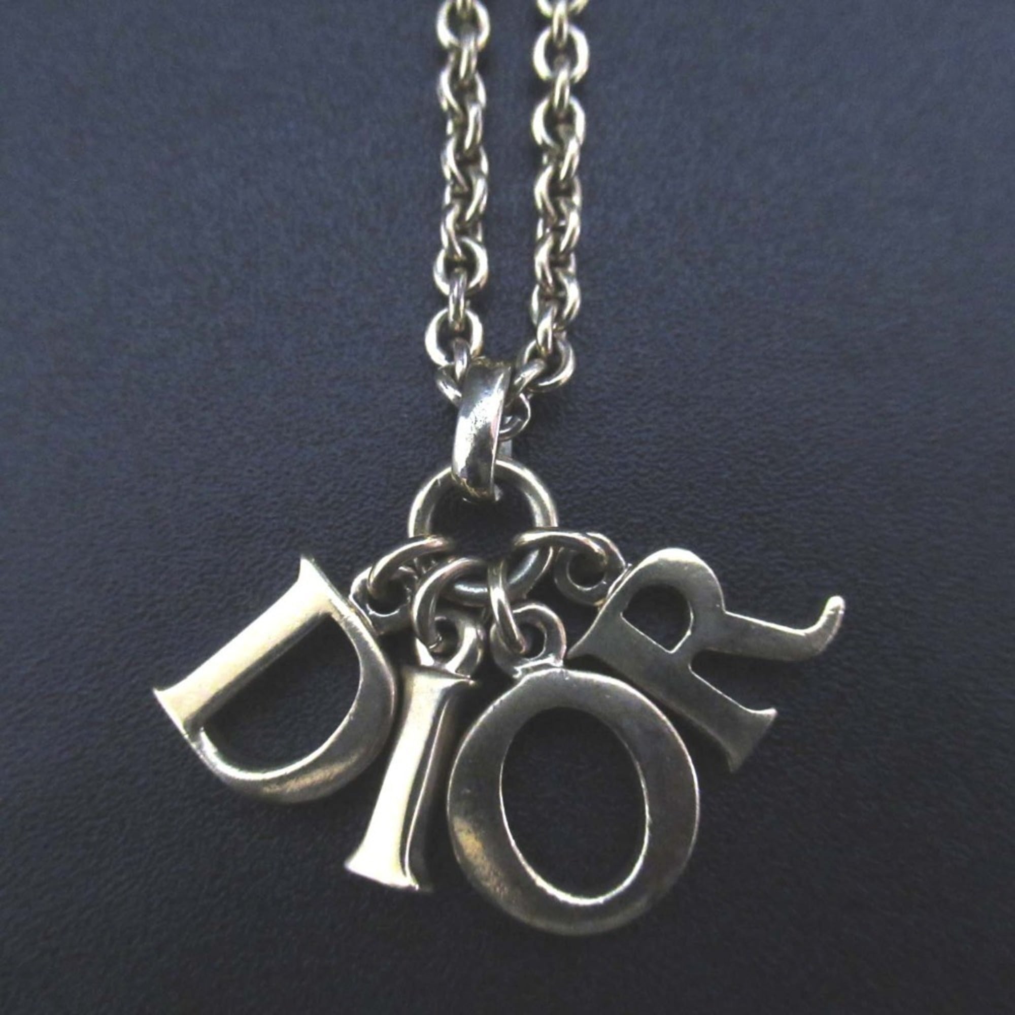 Vintage Christian Dior logo charm necklace pendant in GP gold for women.