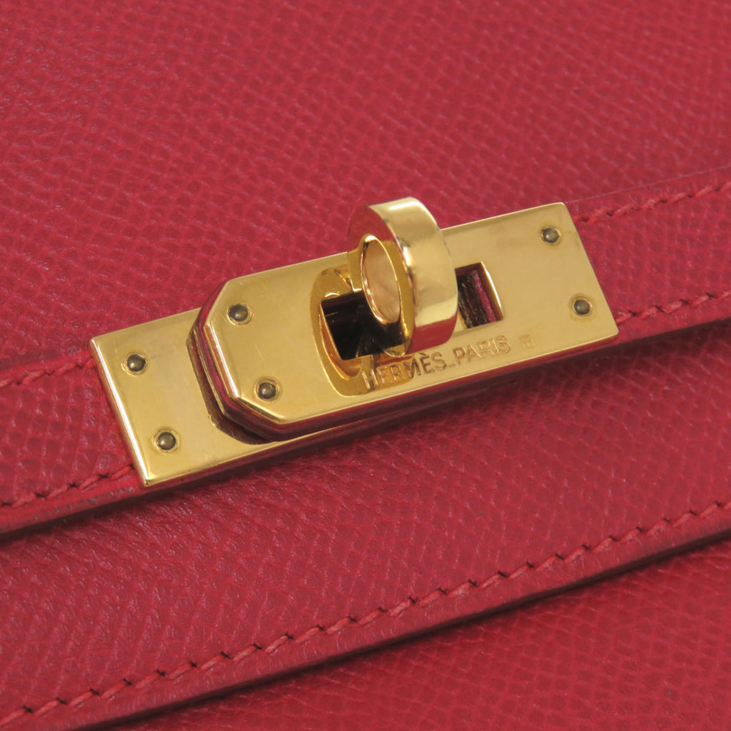 Excellent condition Hermès Banana Kelly Couchbel Rouge vif clutch bag in red with gold hardware and a 〇U stamp. Item number 1465.
