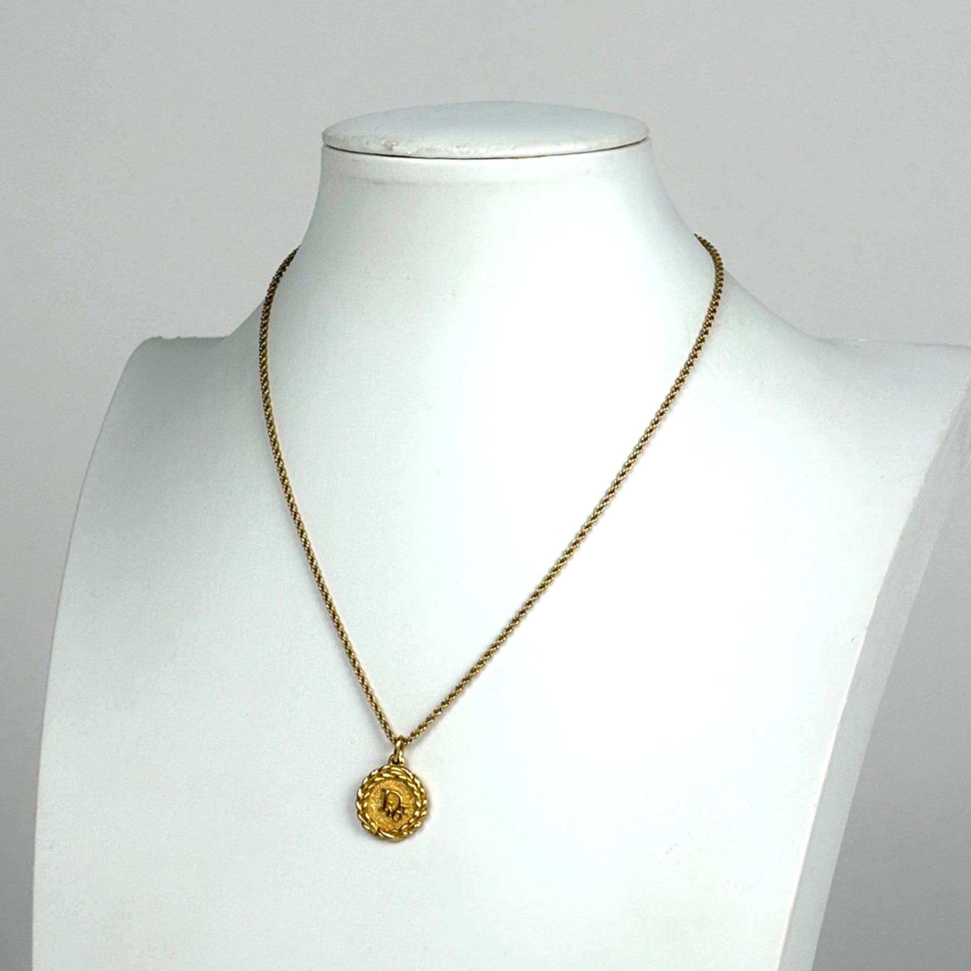 Christian Dior logo round necklace in GP gold for women.