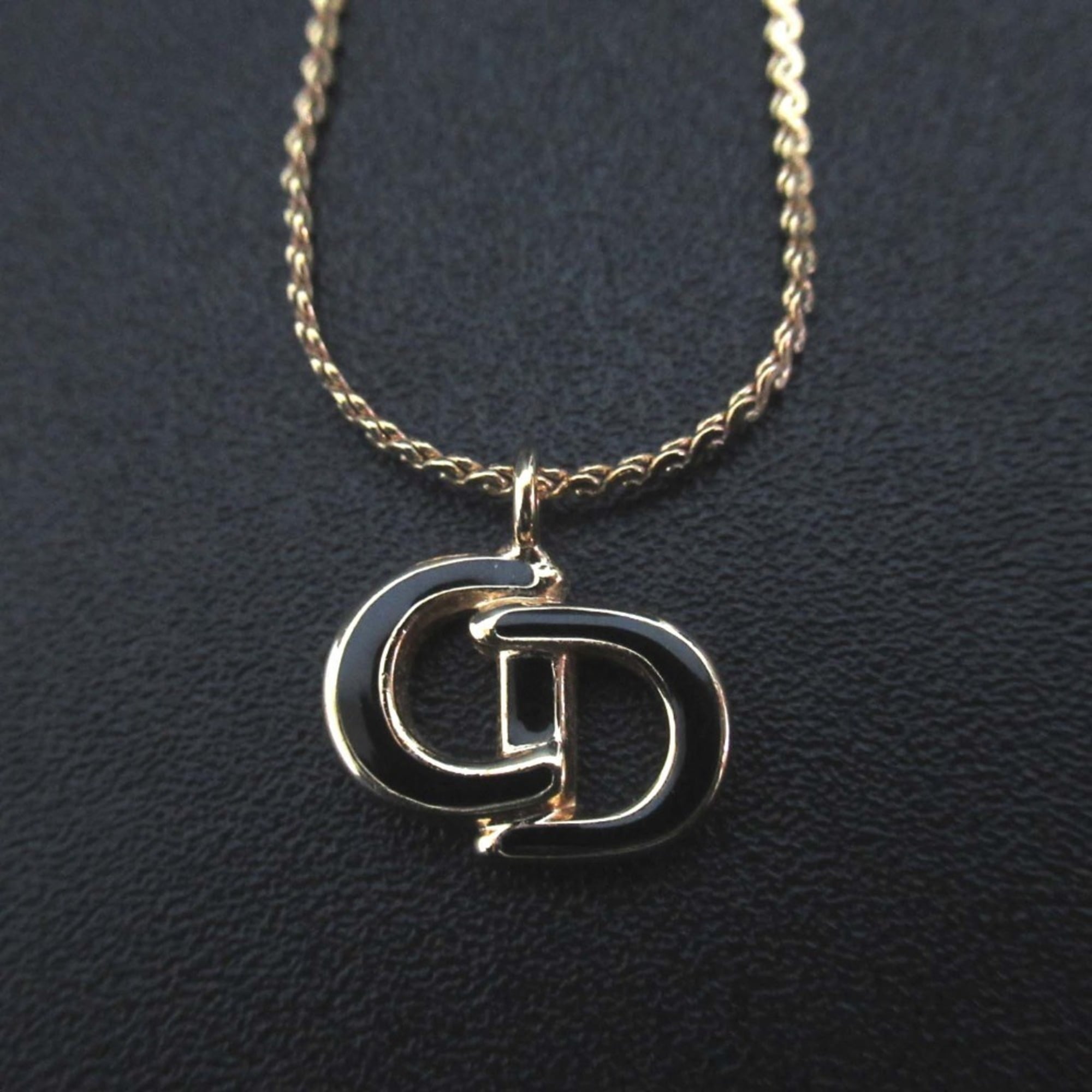 Vintage Christian Dior CD logo necklace pendant in gold for women.
